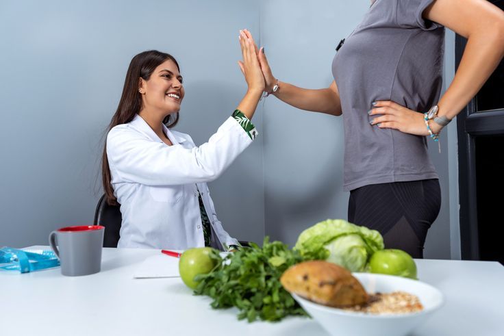 Dietitian is giving high five to his client